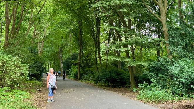 Karen walking in a treed park