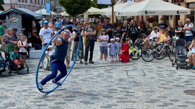 &ldquo;a street performer on a Cyr wheel on a cobblestone street&rdquo;