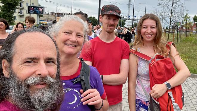 &ldquo;a selfie of four people in a long outdoor queue&rdquo;