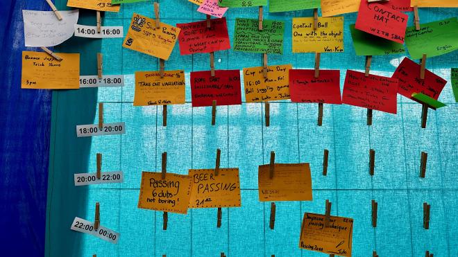 &ldquo;a cloth board with clothespegs and cards describing juggling workshops hanging from them&rdquo;