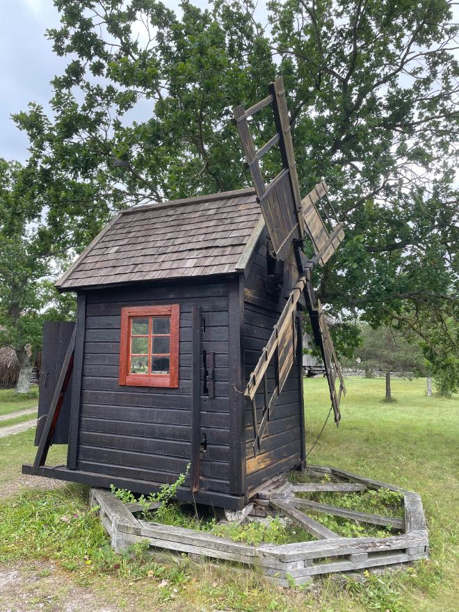 &ldquo;a small wooden shack with a windmill on one side, mounted on an octagonal base&rdquo;