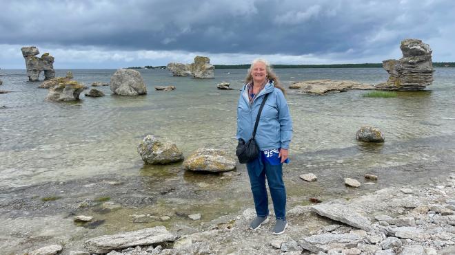 &ldquo;Karen standing beside the sea, with rawks in the background&rdquo;