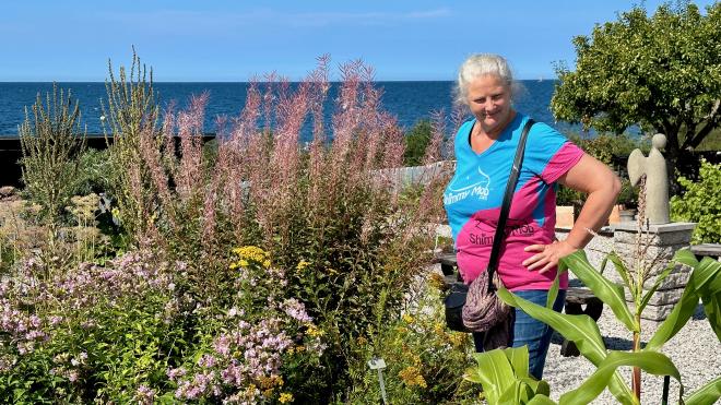 &ldquo;Karen looking at plants in a garden beside the Baltic Sea&rdquo;