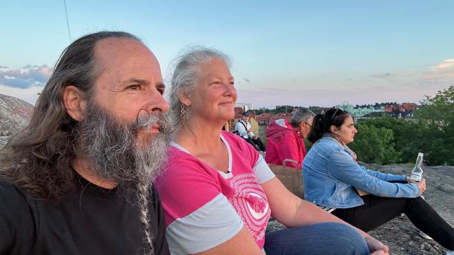 &ldquo;a selfie of Karen and Greg sitting on a rocky hilltop with some other people&rdquo;